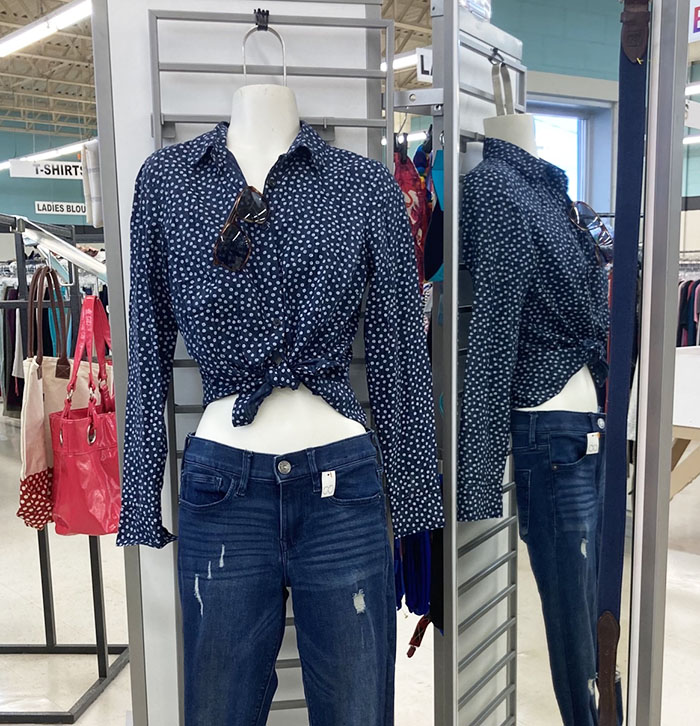 A women's mannequin wears a polka dot shirt and jeans.